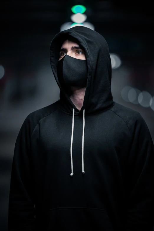 a man wearing a black hoodie and a black mask, a portrait, by Adam Marczyński, reddit, purism, techwear clothes, wojtek fus, street clothing, promo shot