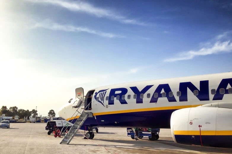 a large jetliner sitting on top of an airport tarmac, a picture, by Raymond Coxon, shutterstock, ibiza, shot with iphone 1 0, ireland, advertising photo