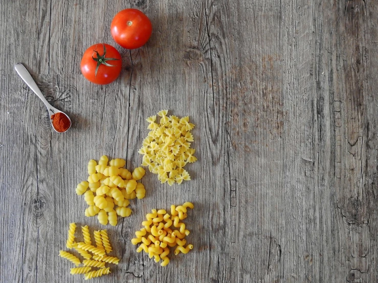 a wooden table topped with pasta and tomatoes, a stock photo, hyperrealism, kitchen background, bird's view, high quality product photo, you can see in the picture