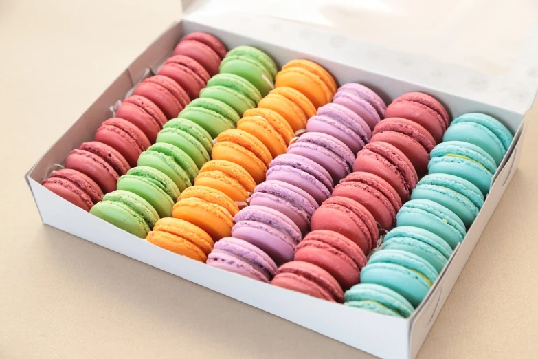 a box of colorful macarons sitting on a table, by Jan Kupecký, highly detailed product photo, high detail product photo, product introduction photo, stock photo