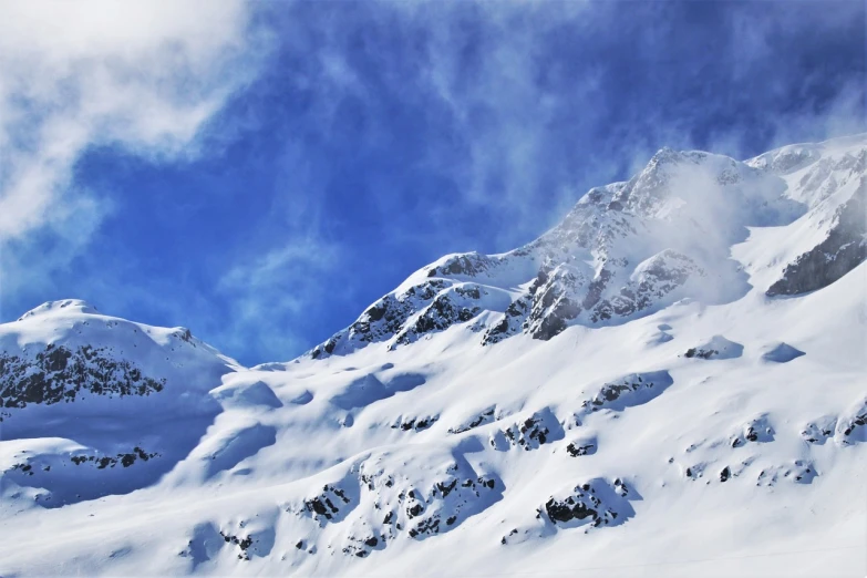 a man riding skis down a snow covered slope, a picture, by Werner Andermatt, pexels, figuration libre, billowing clouds, climbing mountain in washington, superb detail 8 k, wallpaper - 1 0 2 4