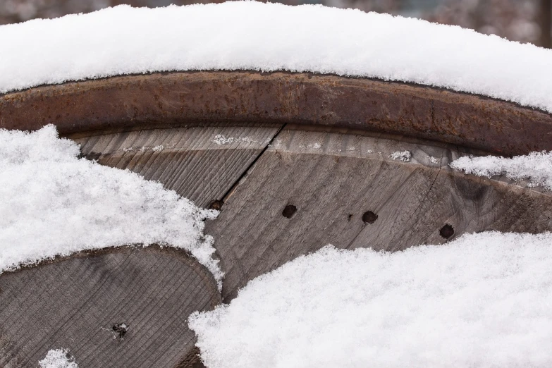 a pile of snow sitting on top of a wooden barrel, by Raymond Normand, flickr, hoog detail, 2 4 mm iso 8 0 0, water wheel, enso