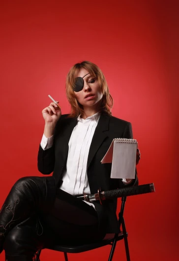 a woman sitting in a chair smoking a cigarette, rock star, holding notebook, on a red background, female investigator