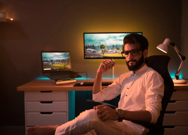 a man sitting in a chair in front of a computer, a computer rendering, inspired by Osman Hamdi Bey, pexels, hyperrealism, cheerful ambient lighting, oled lights in corners, commercial shot, sunset mood