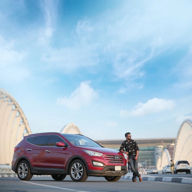 a man standing next to a red suv, by Alexander Fedosav, dubai, hero shot, kyza saleem, beautiful day