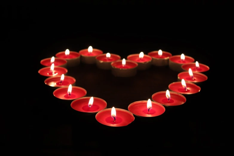 a group of lit candles in the shape of a heart, a picture, wide shot photo, high res photo