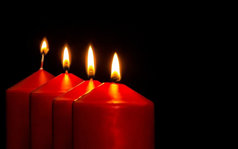 a group of three red candles sitting next to each other, a photo, by Alexander Fedosav, shutterstock, bright on black, in a row, four, epiphany
