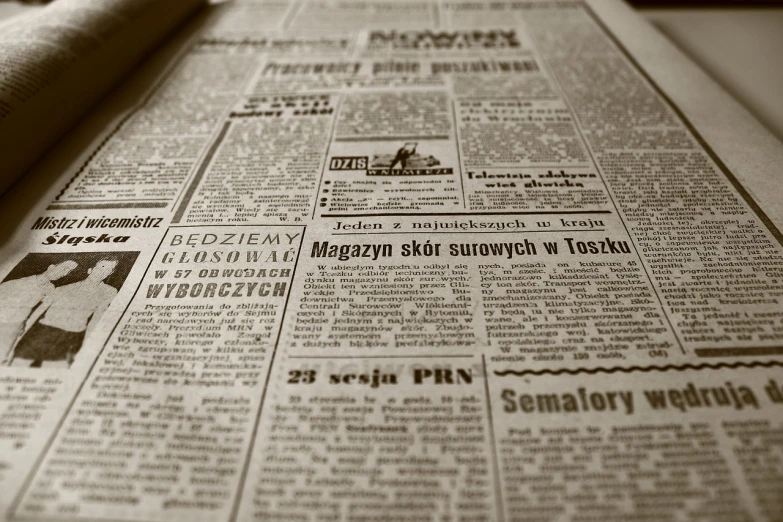 a newspaper laying on top of a table, by Dariusz Zawadzki, old fashion, text, very accurate photo