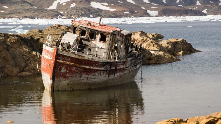 a boat sitting on top of a body of water, by Raymond Normand, shutterstock, rusting, polar, crumbling, well worn