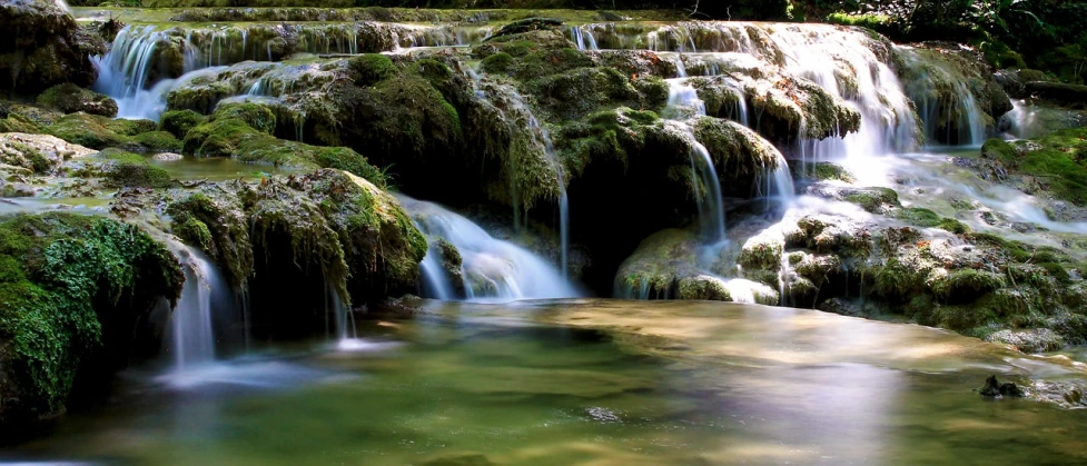 a waterfall in the middle of a lush green forest, by Zoran Mušič, flickr, romanticism, flowing clear water creek bed, multiple waterfalls, deep colours. ”