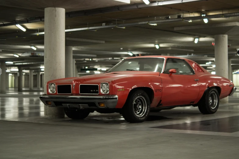 a red car parked in a parking garage, a portrait, by Jan Tengnagel, purism, muscle cars, pacman, square, wallpaper!