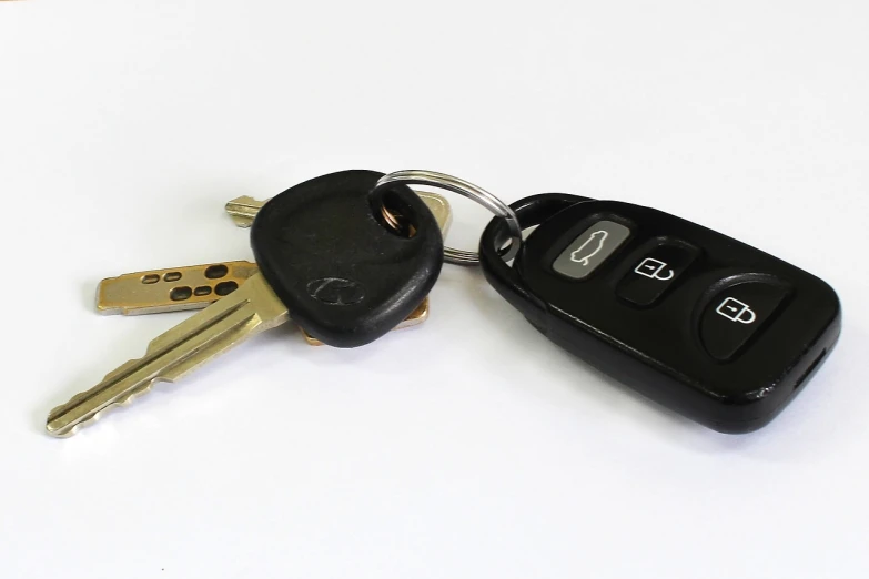 a couple of keys sitting on top of each other, a stock photo, by Tom Carapic, left - hand drive, hero shot, 2000s photo, terminals