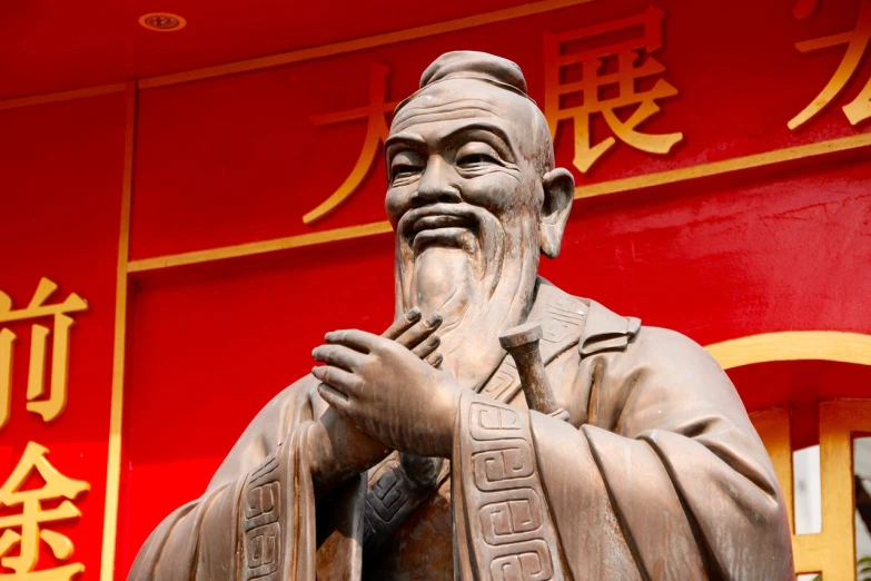 a statue of a man standing in front of a building, inspired by Yang Buzhi, figurativism, emblem of wisdom, he is greeting you warmly, pointed chin, yee chong