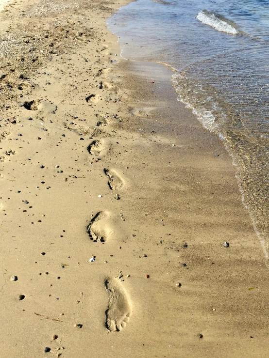 a couple of footprints that are in the sand, a photo, photo taken in 2018, chicago, shoreline, usa-sep 20