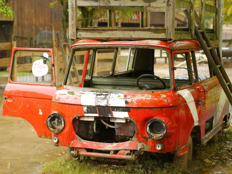 an old red truck with a ladder on top of it, a portrait, auto-destructive art, post apocalyptic theme park, microbus, crazy detail, the ugliest car in the world