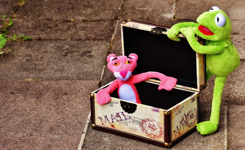 a stuffed animal sitting in a suitcase next to a pink teddy bear, by Toyen, pixabay contest winner, graffiti, pink tigers, muppet show, goblin, hand made