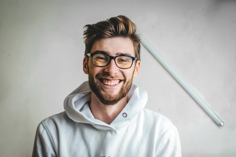 a close up of a person wearing glasses and a hoodie, inspired by Dan Smith, shutterstock, smiling :: attractive, dressed in a white t shirt, luka mivsek, dentist