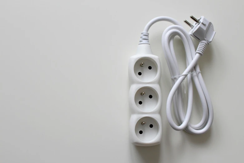 a white power strip sitting on top of a table, a stock photo, inspired by Jan Kupecký, shutterstock, threes, texture, productphoto, patent