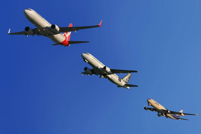 a couple of airplanes flying through a blue sky, flickr, kangaroos, trio, hyperdetailed!!, flying emergency vehicles