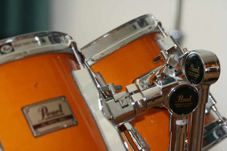 a close up of a pair of drums, a picture, by Thomas Häfner, flickr, orange theme, pearl, drum scanner, trumpet