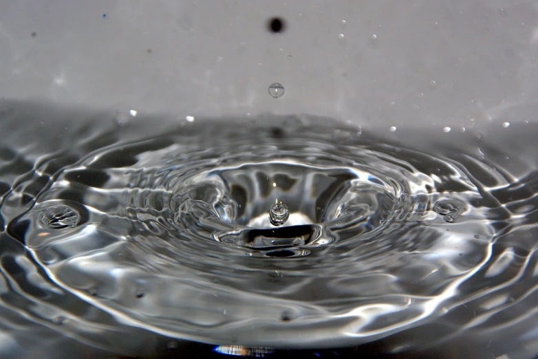 a close up of a water drop in a sink, by Jan Rustem, flickr, renaissance, simulation of water splashes, low angle shot, detailed zoom photo, water pipe