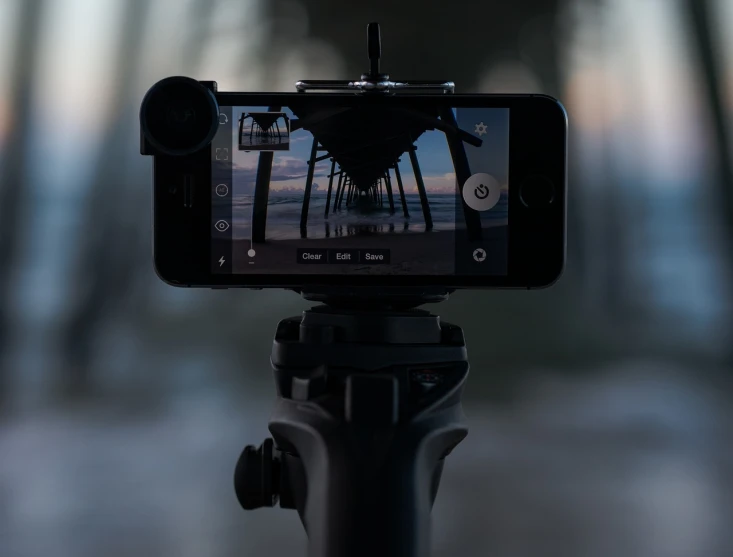 a cell phone sitting on top of a tripod, by Raymond Normand, unsplash, go pro footage, stock footage, apocalyptic setting, architectural shot