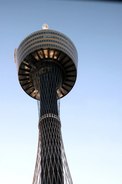 a tall tower with a clock on top of it, inspired by Ned M. Seidler, flickr, hurufiyya, observation deck, nets, water tornado in the city, circular