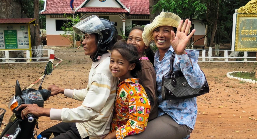 a group of people riding on the back of a motorcycle, a picture, by Jan Rustem, flickr, happy family, cambodia, smiling at camera, avatar image