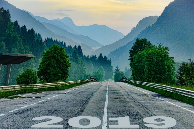 a long empty road with mountains in the background, by Anna Haifisch, trending on pixabay, happening, the year 2089, cover shot, setting is bliss wallpaper, stacked image
