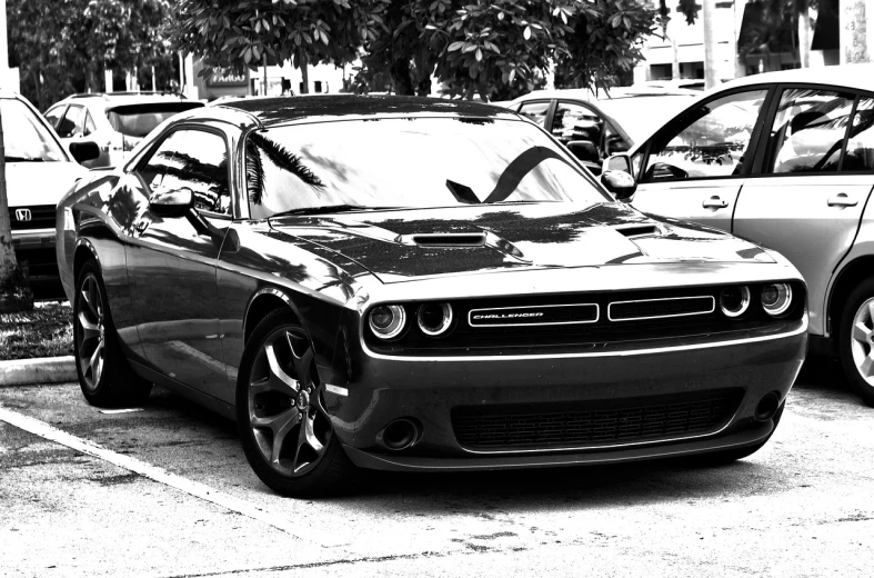 a black and white photo of a car parked in a parking lot, a black and white photo, big muscle, ((oversaturated)), ❤🔥🍄🌪, soft color dodge