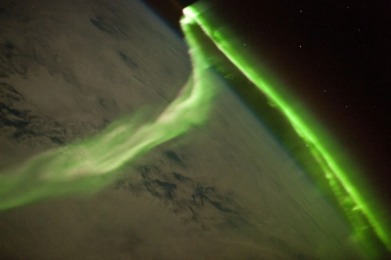 a view of the earth from the international space station, by Erwin Bowien, flickr, strong aurora overhead, swoosh, plasma rays, bright green swirls coming up it