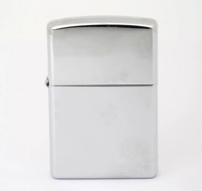 a silver lighter sitting on top of a white surface, lightbox, 90s photo