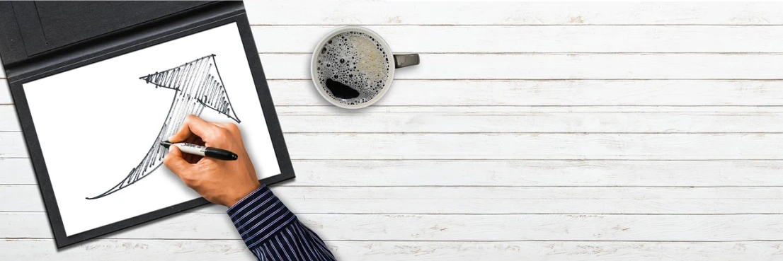 a person drawing on a piece of paper next to a cup of coffee, a stock photo, trending on pixabay, black and white clothes, on a wooden tray, huge cup of coffee, background image