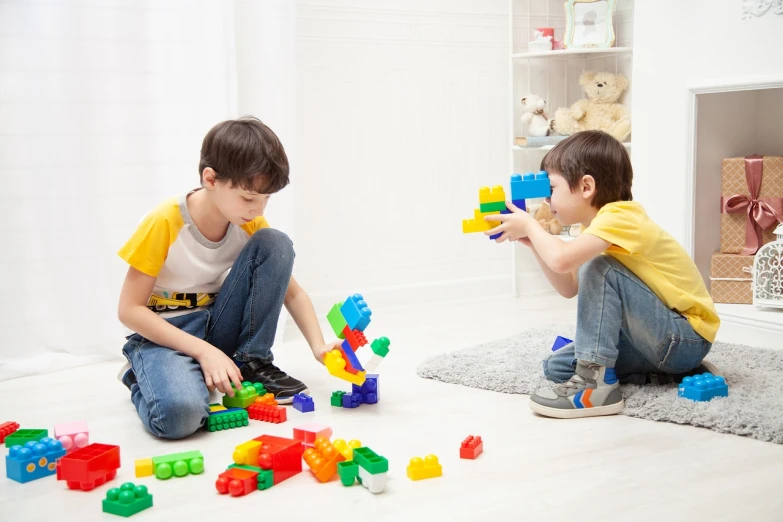 two young boys playing with legos on the floor, shutterstock, destroying the walls, 🕹️ 😎 🔫 🤖 🚬, multiplayer set-piece :9, fisher price