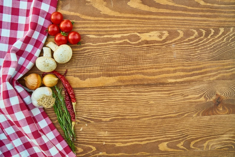a table topped with lots of vegetables on top of a wooden table, a stock photo, realism, background of classic red cloth, birdseye view, product introduction photo