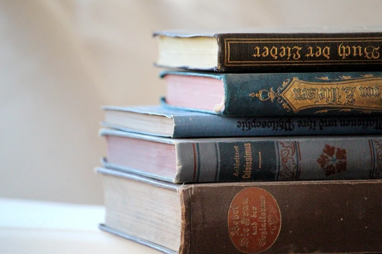 a stack of books sitting on top of each other, by Maksimilijan Vanka, flickr, renaissance, faded and dusty, cutie, looking to the right, elegant study