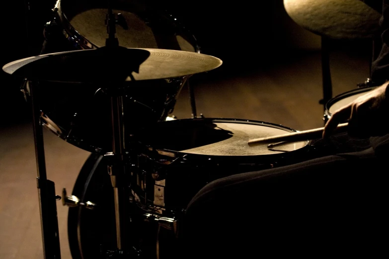 a drum kit sitting on top of a wooden floor, a portrait, by Thomas Häfner, flickr, on deep black velvet, random detail, detailed zoom photo, shadow