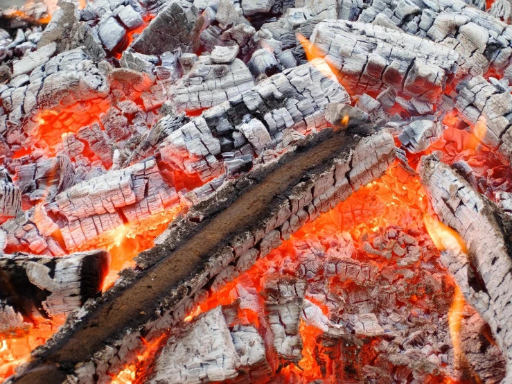 a pile of wood sitting on top of a fire, a picture, by Rodney Joseph Burn, shutterstock, red narrow lava rivers, view from above, ashes to ashes, high quality product image”