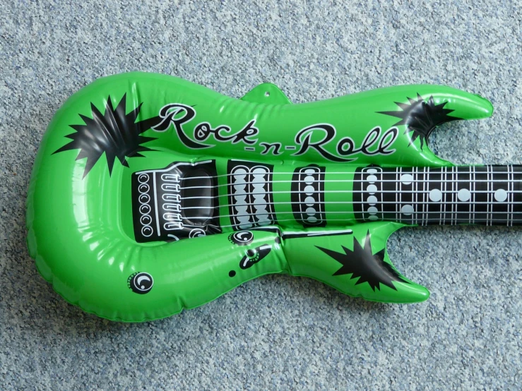 an inflatable guitar shaped like a rock'n roll, a picture, inspired by Mirko Rački, flickr, green, detailed picture, rock n roll, 7 7 7 7