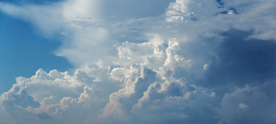 a plane flying through a cloudy blue sky, a picture, by Jan Rustem, cumulus cloud tattoos, voluminous clouds, sky - high view, angels in the sky