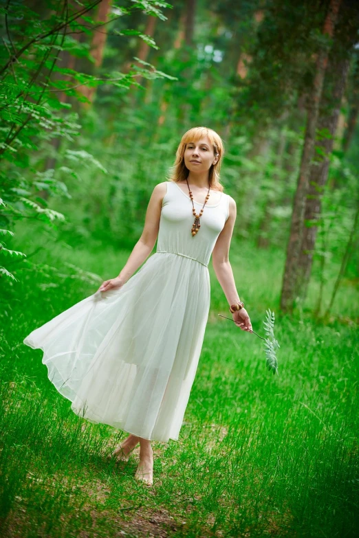 a woman in a white dress walking through a forest, a picture, by Ivan Grohar, shutterstock, romanticism, in a open green field, full body cute young lady, female figure in maxi dress, blond