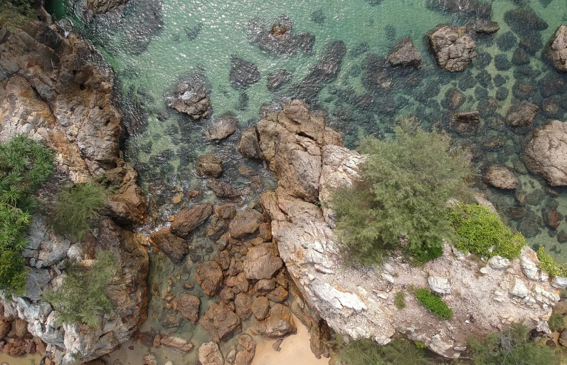 a bird's eye view of some rocks and water, by Bascove, manly, ((rocks)), abel tasman, interesting background