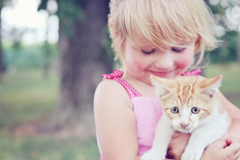 a little girl holding a kitten in her arms, a picture, by Julia Pishtar, hr ginger, featured, 1 2 9 7, edited