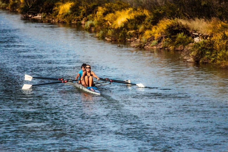 a woman rowing a boat down a river, by Lee Loughridge, shutterstock, purism, couple, sport photography, new mexico, twins