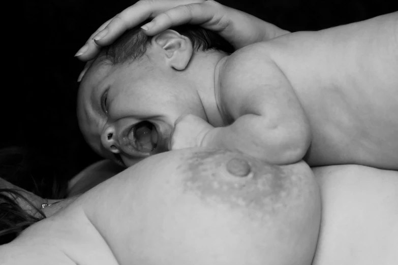 a close up of a person holding a baby, a black and white photo, by Eugeniusz Zak, massurrealism, breasts covered and sfw, screaming in pain, 8 k photo, pudica pose bouguereau style