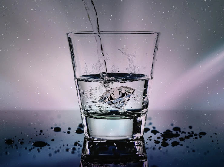 a glass filled with water sitting on top of a table, by Jan Rustem, pexels, photorealism, water is made of stardust, face in water, running water, detailed product photo