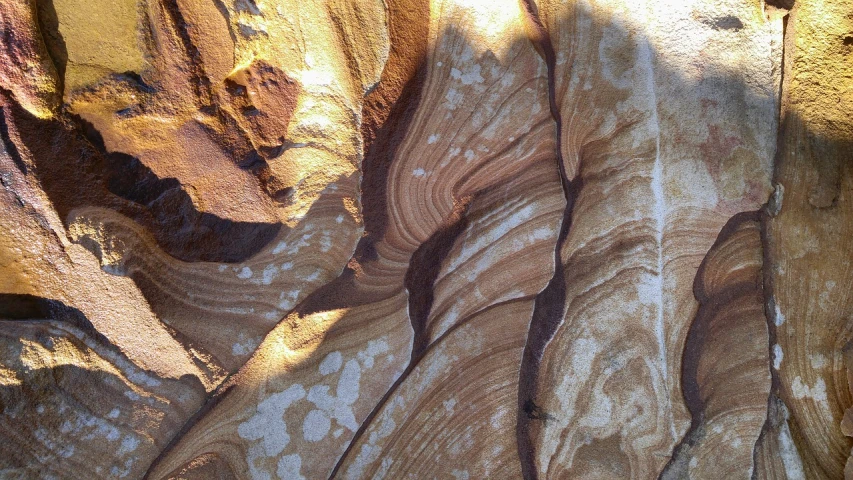 a close up of a rock formation in the desert, by Lee Loughridge, shiny layered geological strata, sydney, ancient swirls, coastline