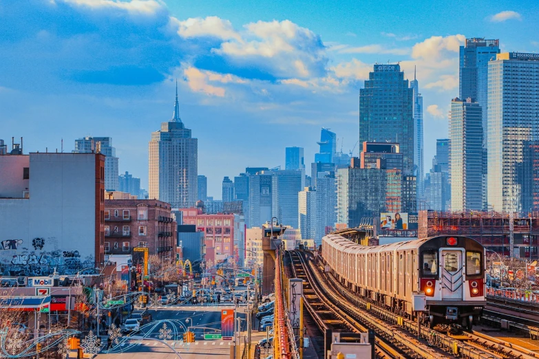 a train traveling through a city next to tall buildings, a stock photo, by Emanuel Witz, shutterstock, new york skyline, subways, vibrant vivid colors, day cityscape