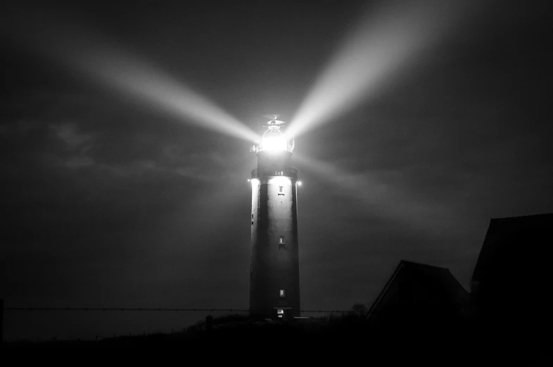 a black and white photo of a light tower, by Jan Pynas, pexels, flashlight on, where a large, glowing with silver light, a large