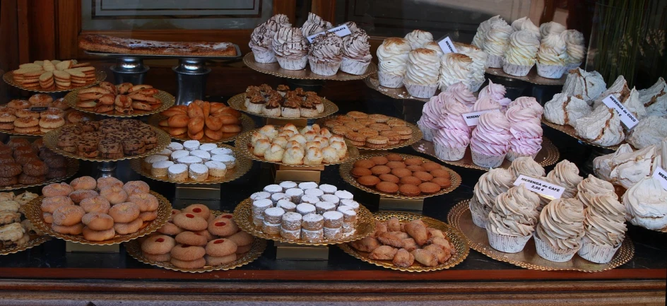 a display case filled with lots of different types of pastries, a photo, by Dietmar Damerau, pexels, art nouveau, wikimedia commons, traditional corsican, macaron, 3 4 5 3 1